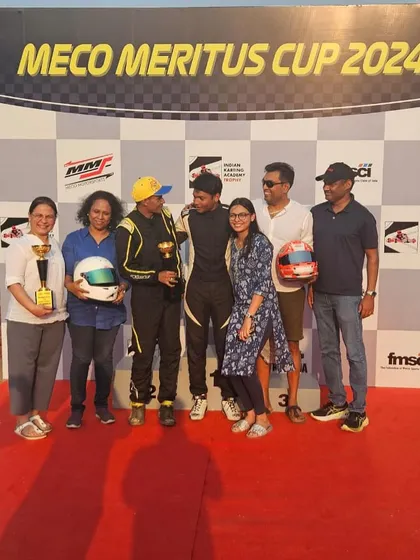 The team and families celebrating a double podium finish.