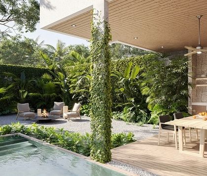The same patio design in daylight, revealing the lushness of the vertical garden and surrounding plants. The space is designed to feel like a private jungle retreat, complete with a pool and full outdoor kitchen.