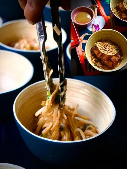 A collage showing the preparation of a noodle dish. Tongs lift a tangle of noodles into a bowl, ready to be combined with a rich sauce and toppings, showcasing the final steps of our live noodle bar.