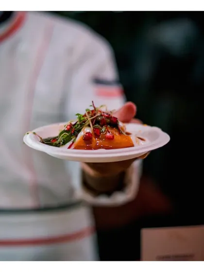 A beautifully plated dish held by a chef, showcasing a modern Indian appetizer. This is a duplicate of ID 12, reinforcing the image of our artfully presented, chef-crafted food.