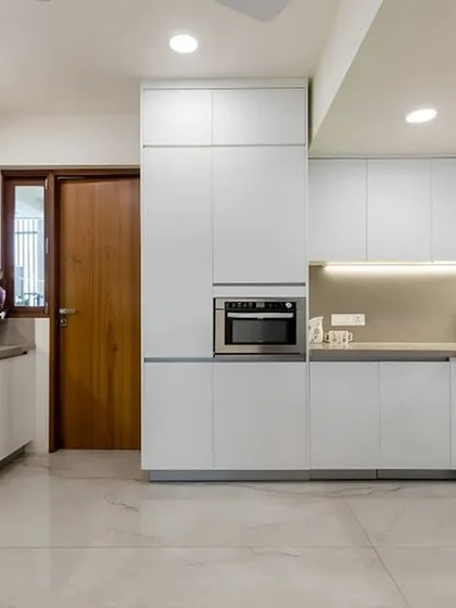 A clean, all-white modular kitchen I designed for a modern Bengaluru home. This layout maximizes counter space and storage with sleek, handleless cabinets and integrated appliances for a minimalist and highly functional cooking area.