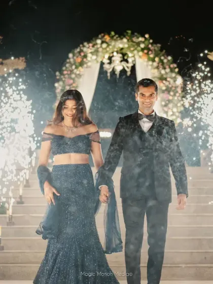 A grand entrance for the couple at their reception, walking through a tunnel of sparklers held by their loved ones. I orchestrate these high-impact moments to create unforgettable memories.