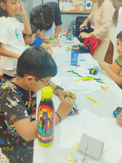 Another group of kids working on their projects, including a custom-designed Robo Car. They get to decorate and build their creations from scratch.