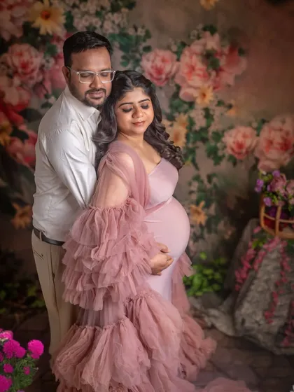 A classic couple's pose, embracing from behind. This intimate portrait beautifully captures their connection and shared joy.