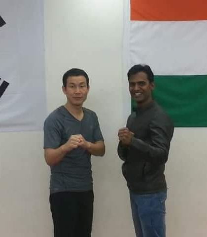 With a Korean Taekwondo Master, standing before the flags of Korea and India. I believe in learning from the origins of the sport to be a better coach.