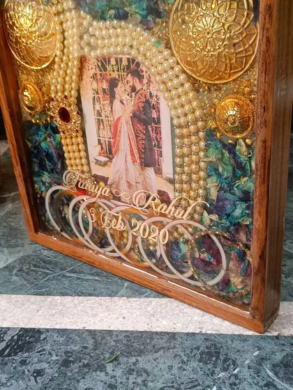 Another angle of the orchid and ornament wedding frame. The depth of the frame allows for a beautiful 3D arrangement of the couple's most precious wedding day items.