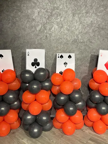 A fun and unique decoration for a casino themed party. We created these structures using balloons and oversized playing cards.