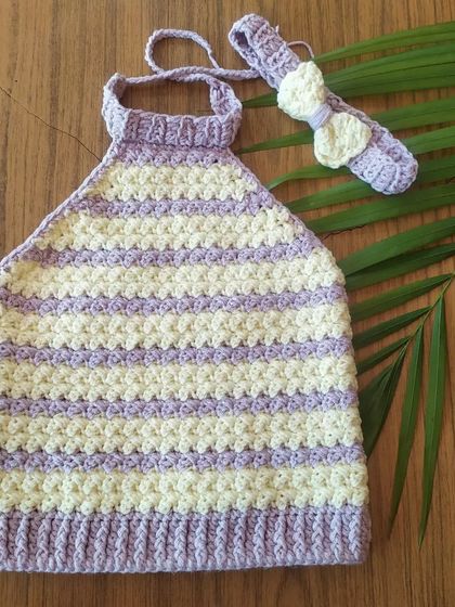 A flat lay of the Lavender Halter Top and matching headband. The textured stitch pattern is beautiful up close, and the set is made from a soft baby modal yarn.