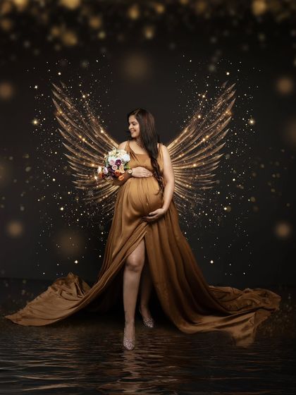 When I envisioned capturing this ethereal moment, I knew it had to be magical. This portrait with golden angel wings reflects the strength and beauty of motherhood.
