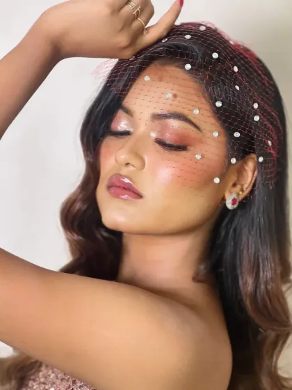A dreamy, ethereal shot with eyes closed, showcasing the glossy, shimmery eyeshadow and the perfectly highlighted skin.