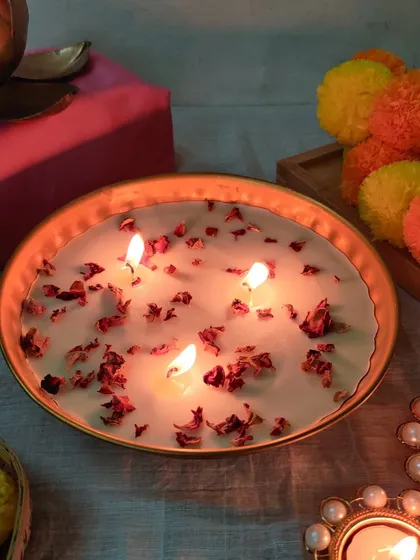 Our rose petal candle bowl glowing warmly, creating an inviting atmosphere. This is a must-have for setting a serene and festive mood.