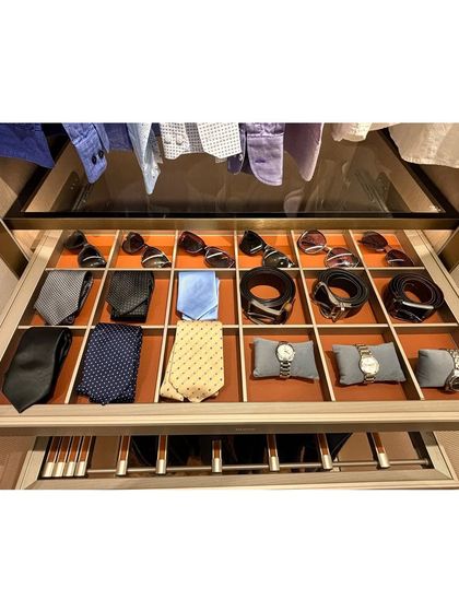 A perfectly organized drawer for men's accessories. We created custom compartments for ties, belts, and watches, ensuring each item has its own designated spot.