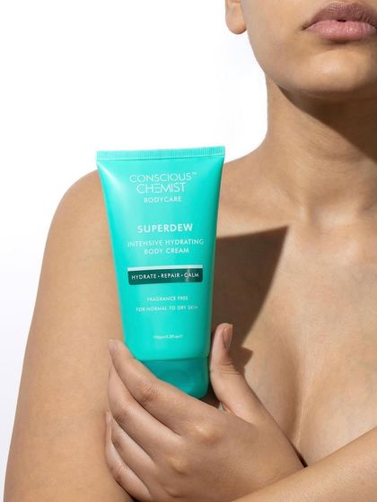 This lifestyle shot focuses on the connection between skin and product. The model holding the vibrant body cream creates a sense of personal care and self-love, making the image feel intimate and relatable.