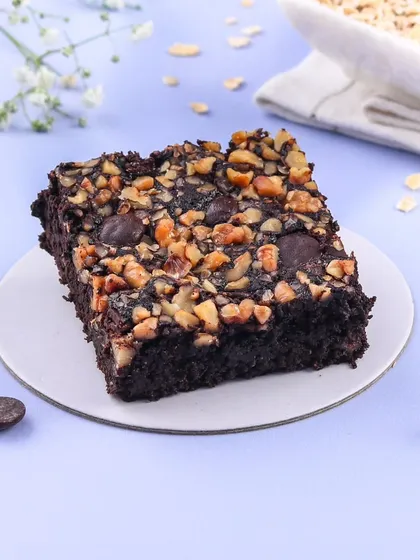 Our Oats Jaggery Brownie is a healthier but equally delicious option. It's made with oats and sweetened with jaggery, topped with chocolate chips and nuts for a satisfying crunch.