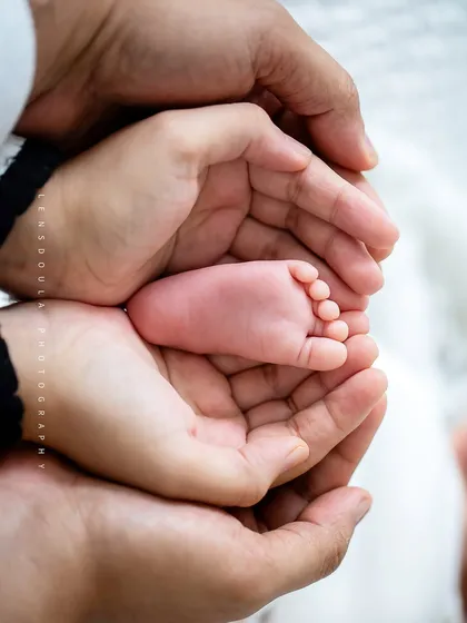 Held safe and sound in your hands. This classic newborn shot of tiny feet cupped by loving parents is a powerful reminder of how small they once were.