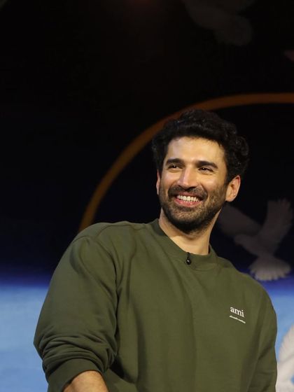 Aditya Roy Kapur's genuine smile is the best accessory. The simple, well-fitting sweatshirt is the perfect canvas.