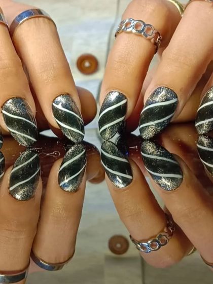 A dramatic black and silver glitter design with diagonal white stripes for a modern, edgy look.