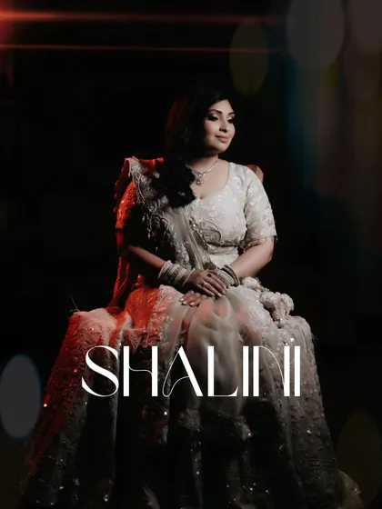 A stunning solo portrait of the bride, Shalini, seated gracefully, her elegant gown and serene expression creating a picture of pure class.