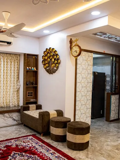 This seating area combines traditional Indian elements, like the ornate rug and brass decor, with modern furniture for a unique, eclectic look.