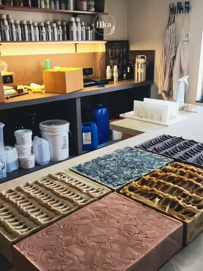 A wide shot of my studio, with multiple large soap loaves set and curing. This is where I make it easy for you to get into the plant-based wellness market. Let's grow together.