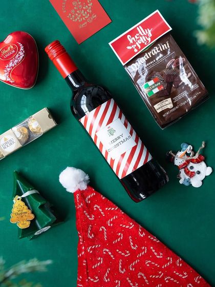 A deconstructed view of the 'Jolly Feast' hamper, highlighting the fun and festive items inside.