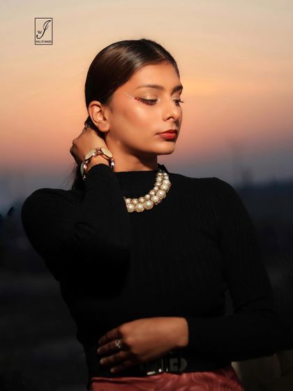A profile shot against the fading sunset, creating a beautiful silhouette and a moody, contemplative portrait.