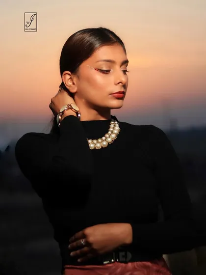 A profile shot against the fading sunset, creating a beautiful silhouette and a moody, contemplative portrait.