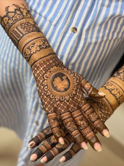 A classic baby shower design with a baby carriage motif as the central element on the palm, surrounded by intricate patterns.