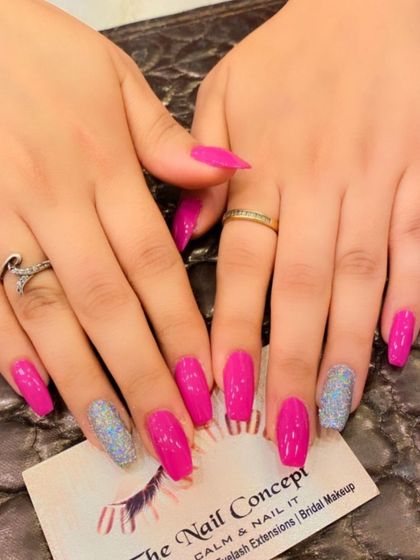 A striking set of hot pink coffin nails. The design is balanced with two silver holographic glitter accent nails for a cool-toned sparkle.