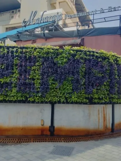 We help businesses stand out with custom-branded green walls. For this restaurant, we designed a living sign using contrasting purple and green plants, creating an unforgettable, eco-friendly facade that welcomes guests.