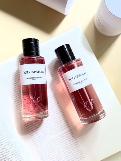 Two Christian Dior Oud Ispahan bottles, beautifully engraved with initials. The script flows with the elegance of the fragrance itself.