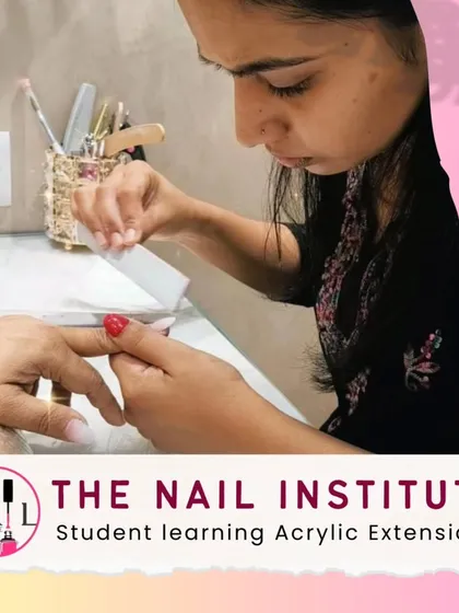 This student is practicing the application of acrylic extensions, a core skill covered in our professional nail technician program.