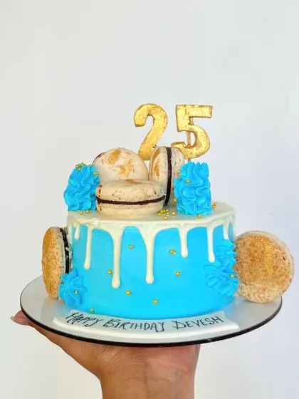 The cutest cake ever? I think so. This mini cake features a bright blue drip, macarons, and a gold '25' topper, perfect for a milestone birthday.
