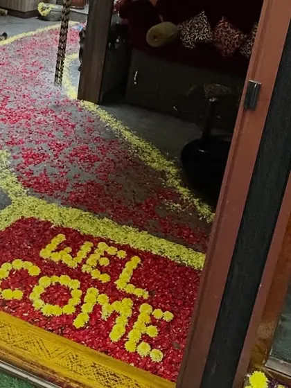 A creative and beautiful welcome message made entirely of flower petals on the floor, offering a unique and fragrant greeting to guests.