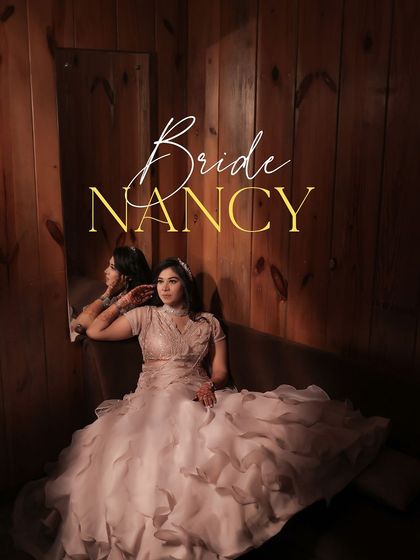 A beautiful portrait of the bride, Nancy, on her Roka day. She leans against a mirror in a room with warm wood paneling, her ruffled gown and thoughtful expression creating an elegant and artistic image.