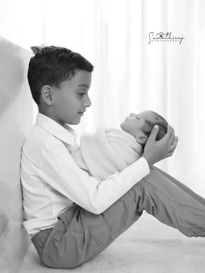 The moment a big brother meets his new sibling is pure magic. I captured this tender portrait in black and white to create a timeless feel, focusing entirely on the gentle connection and love between them.
