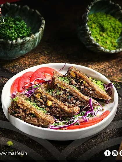 Kibbeh Sajieh, a traditional Lebanese delicacy. These savory pastries are filled with seasoned minced meat and nuts, then fried to create a wonderfully textured and flavorful starter.