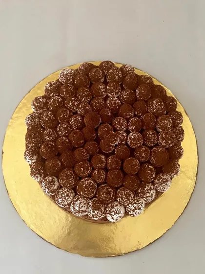 The perfect pairing of Dark Chocolate and Coffee. This cake is intense, aromatic, and deeply satisfying, topped with coffee-flavoured truffles for an extra kick.
