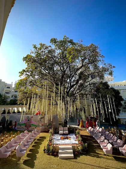For this wedding at Kumbhalgarh, I designed a serene mandap under a magnificent tree, adorned with hanging floral strings. This setup blends natural beauty with sacred tradition, creating an intimate and breathtaking space for the couple's vows.