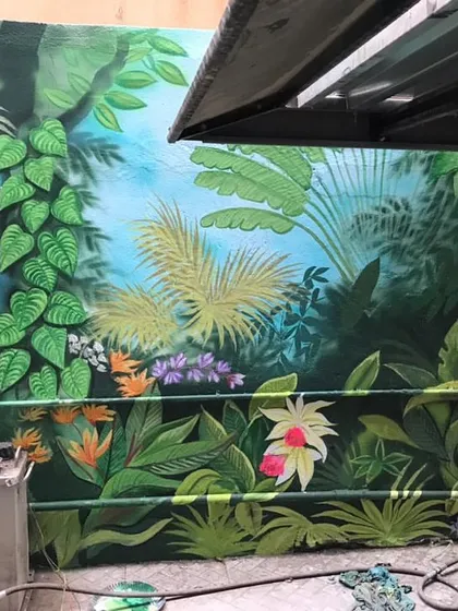 Another section of the dense jungle mural, showcasing the variety of leaves and flowers I used to create a rich, layered look.