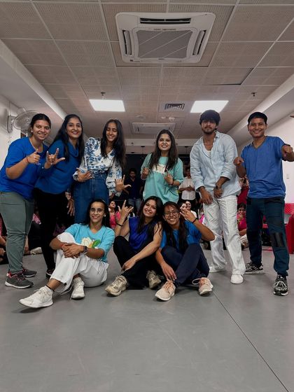 The "Water" performance crew posing after their smooth routine. The coordinated blue color scheme and relaxed poses perfectly match the vibe of their dance.