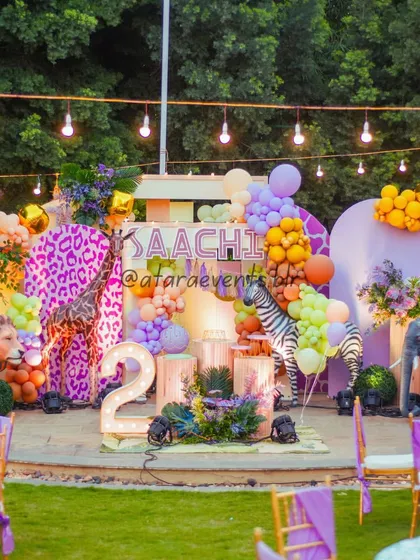 I bring the wild outdoors to your party with vibrant jungle themes. This setup features life-sized animal props, lush greenery, and a custom stage, perfect for an adventurous second birthday celebration.