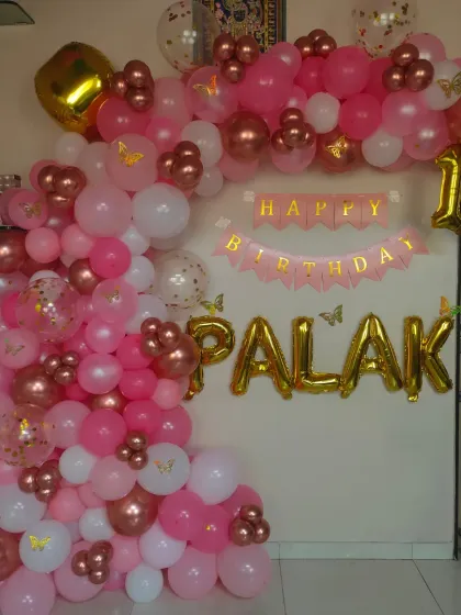 A slightly different angle of the 'Palak' 17th birthday setup, showing the depth and layering of the different colored and sized balloons in this L-shaped arch.