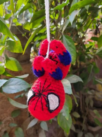 Your friendly neighborhood Spider-Man, in crochet form. This amigurumi hanging toy is perfect for decorating a kid's room or even a car mirror.