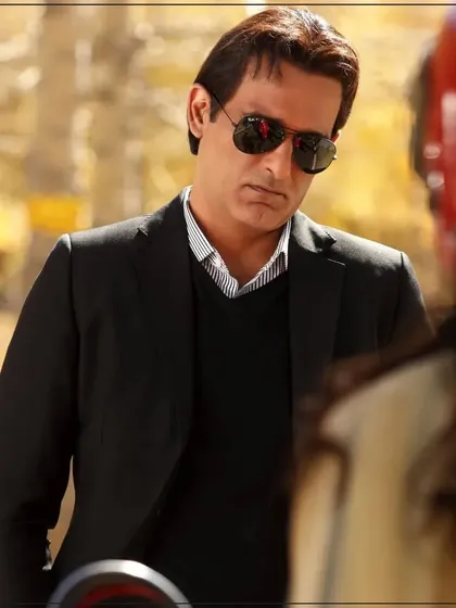 A candid shot of actor Akshaye Khanna wearing a custom black suit. This demonstrates the versatility and effortless style of my tailored pieces, suitable for any setting.
