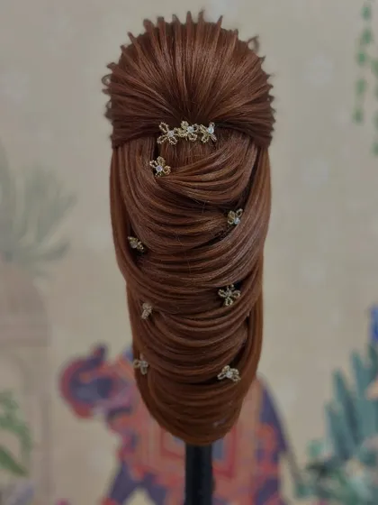 This unique and structured hairstyle was created by a student during our practice sessions. We encourage creativity alongside technique.