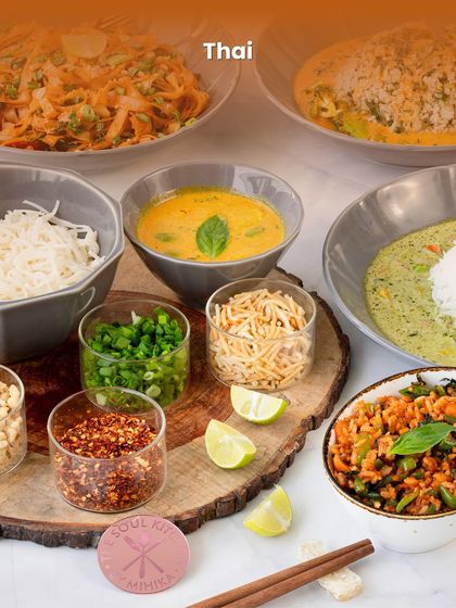 A complete Thai meal setup, including fragrant curries and noodles, perfect for a seated dinner party.
