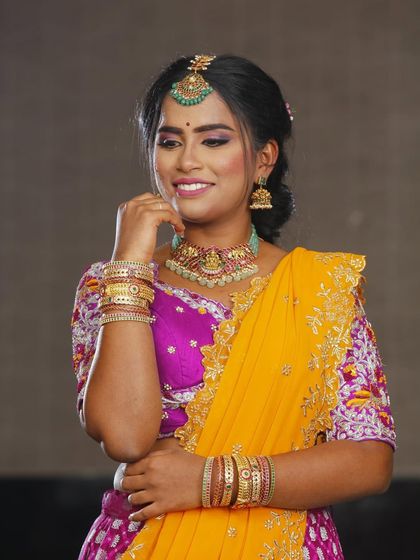 A happy and confident portrait. The makeup is celebratory and fun, perfect for dancing the night away at a wedding or sangeet.