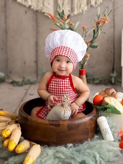Meet the cutest little chef in town! This six-month milestone session was a fun, food-themed shoot complete with a chef's hat and fresh veggies.