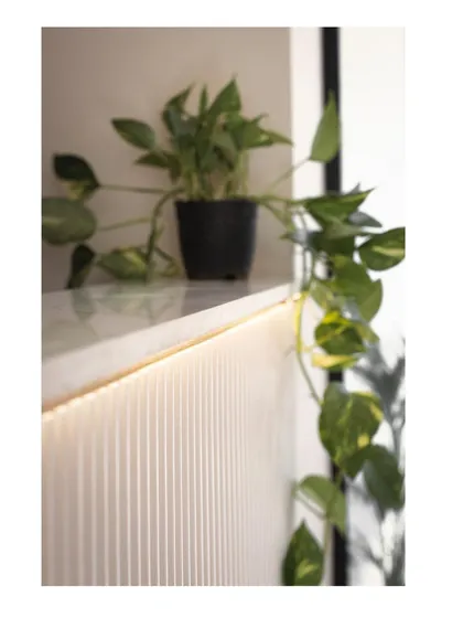 A close-up of the under-shelf lighting, a small detail that adds a layer of warmth and sophistication to the design.